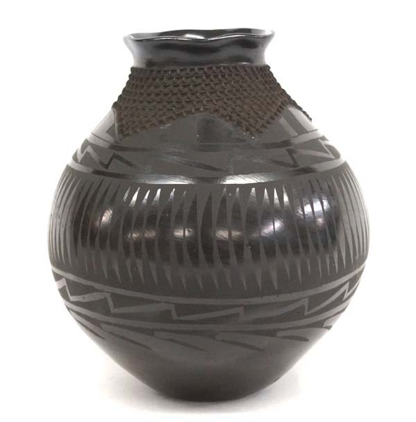 Mexican Mata Ortiz Black on Black Jar by Gonzalez: Mexican Mata Ortiz Black on Black Jar by Jose Gonzalez, measures 9.5''H x 9''W, highly burnished gun metal finish, fluted rim, textured neck, stylized feather designs, signed by artist