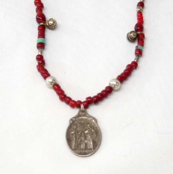 Red and White Heart Trade Bead Necklace: Red and White Heart Trade Bead Necklace, measures 17'' end to end and is embellished with sterling accent beads, turquoise heishi, and glass beads, the pendant is a Catholic A SS. Patre Benedicta Meda