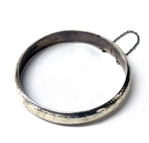 Sterling Silver Bangle Bracelet: Sterling Silver Bangle Bracelet, inside measures 8'' x .5''W, equipped with guard chain, etched details