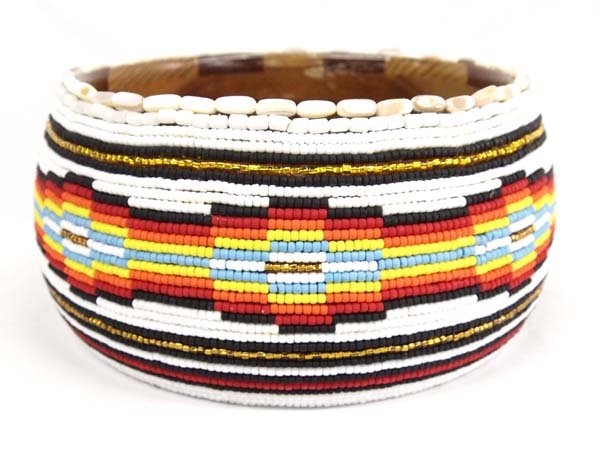 Hand Beaded Wooden Bowl by Kills Thunder: Hand Beaded Wooden Bowl by Kills Thunder. With its colorful and intricate design, this piece measures 5 x 8. Kathleen Kills Thunder was born in Seattle, Washington. Kathy has been painting and beading