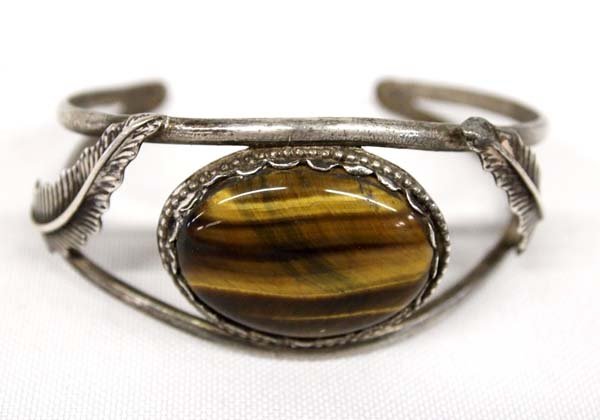 Vintage Navajo Sterling Silver Tigers Eye Bracelet: Vintage Native American Navajo Sterling Silver Tiger's Eye Bracelet, inside measures 7'' which includes opening x 1.25''W, leaf on one side of piece needs to be soldered