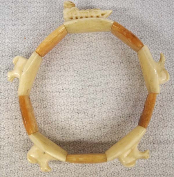 Inuit Carved Ivory and Bone Iditarod Bracelet: Native American Canadian Inuit Carved Ivory and Bone Iditarod Dog Sled Bracelet, adjustable (on stretch band), features dog sled and 7 dogs and musher, fossilized honey colored bone, exquisite detail