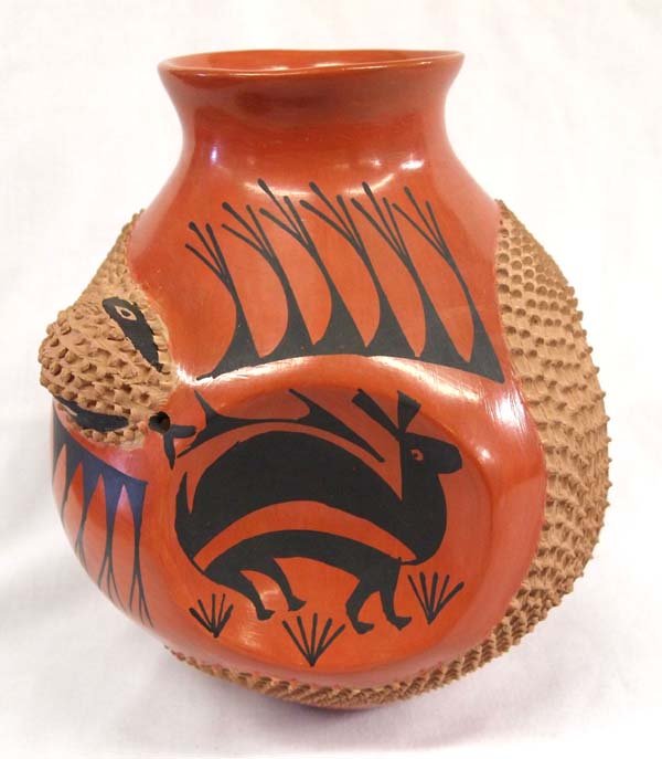 Mexican Mata Ortiz Textured Jar by Jose Gonzalez: Mexican Mata Ortiz Textured Jar by Jose Gonzalez, signed by artist and measures 9.5''H x 9''D, features 4 concave rabbit medallions, highly textured rattlesnake
