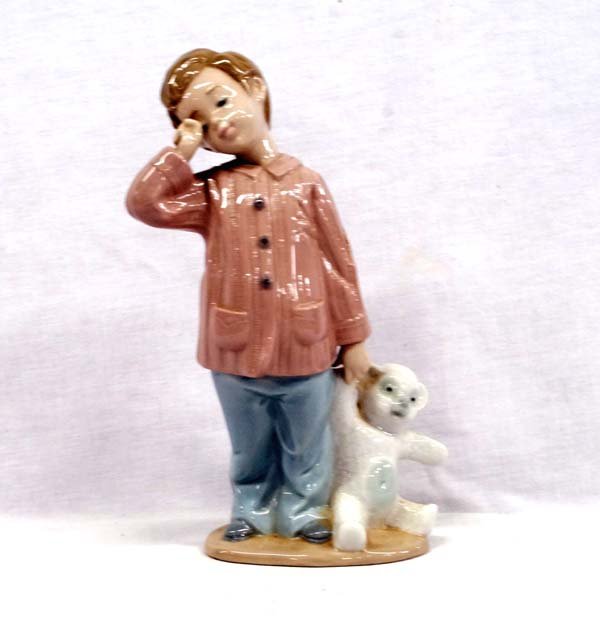 Sleepy Child Porcelain Figure by Lladro: Sleepy Child Porcelain Figure by Lladro. Stamped with a hallmark and DAO Handmade in Spain. This piece measures 7''H x 3''W x 2''D.