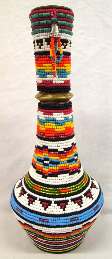 Kills Thunder Beaded Brass Vase: Kills Thunder Beaded Brass Vase Measures 15''H x 7''W. Kathleen Kills Thunder was born in Seattle, Washington. Kathy has been painting and beading since she was six. She uses bright color palette and 
