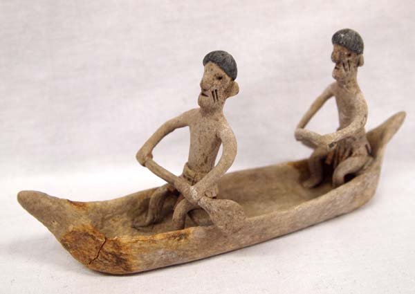 Amazonian Indigenous Men in a Canoe: Amazonian Indigenous Men in a Canoe. Made from Rubber as Part of a Brazilian Project to Employ Former Rubber Plant Workers. measure 6''L x 3''H