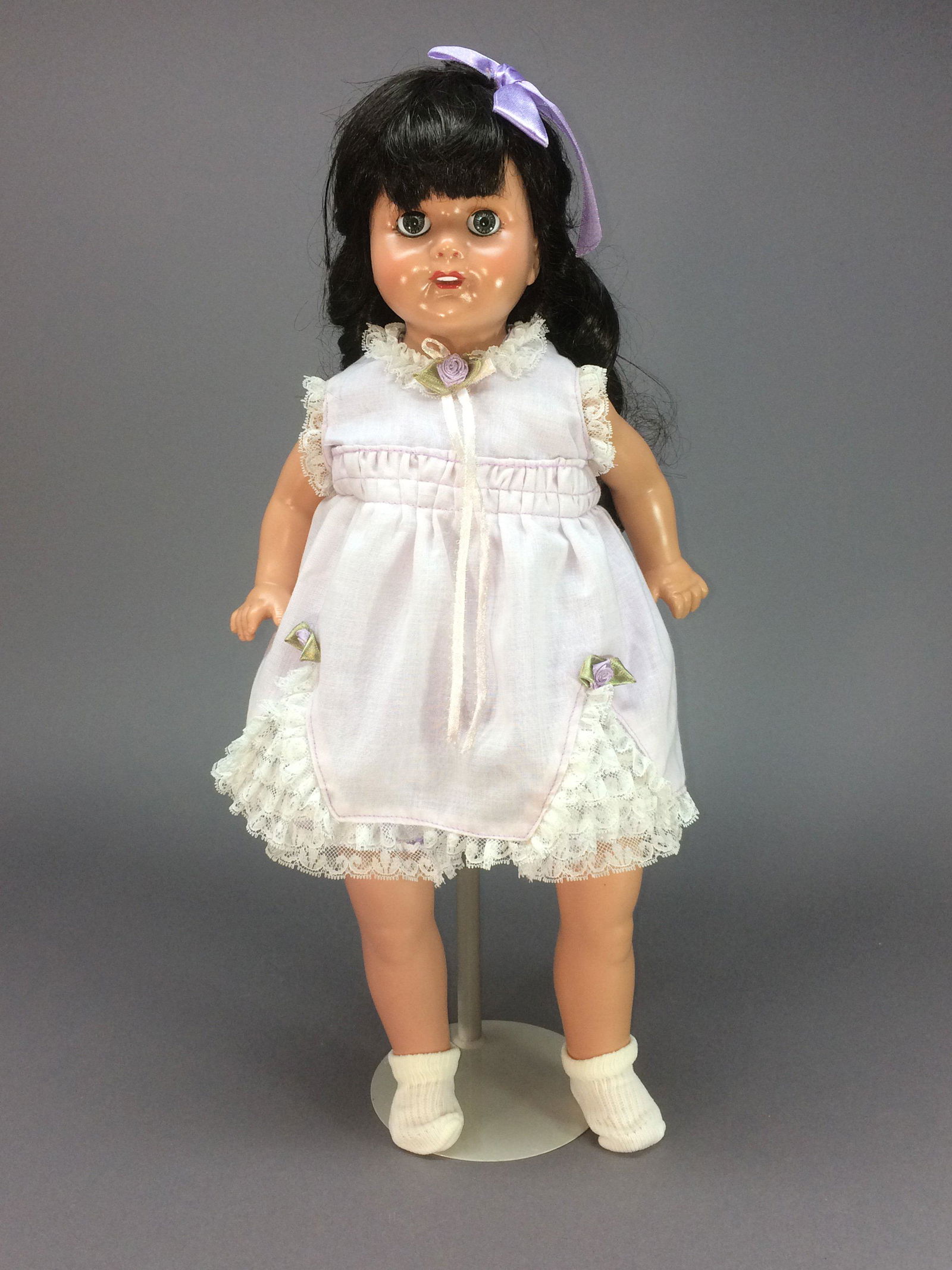 Effanbee Vinyl Rosemary Reproduction Mama Doll: Rosemary by Effanbee is a reproduction of their original 1920s composition doll. This 1990s version is 18” tall (45.7 cm) with a vinyl head and limbs with a cloth body. She has raven black hair in s