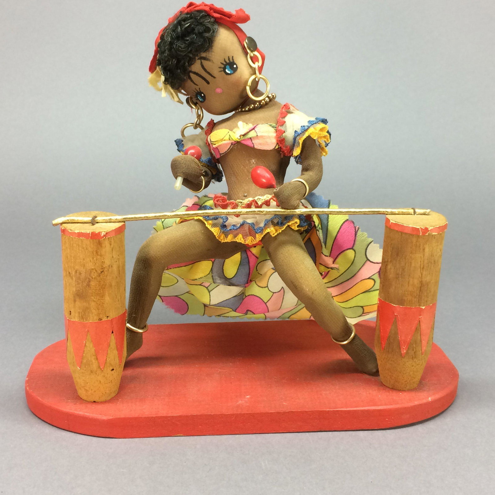 Caribbean Limbo Dancer Doll – Vintage Souvenir: This limbo dancer doll measures about 8” tall (30.5 cm) including her wooden base. She is made of some hard material covered with nylon stockinette, with painted features and curly synthetic hair. S