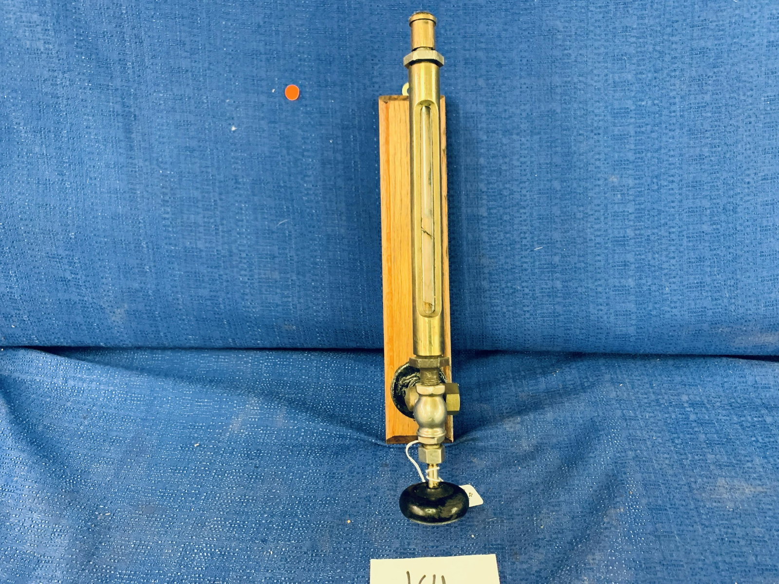 Brass Sight Gauge with Valve: Brass Sight Gauge with Valve mounted on wood, glass is cracked