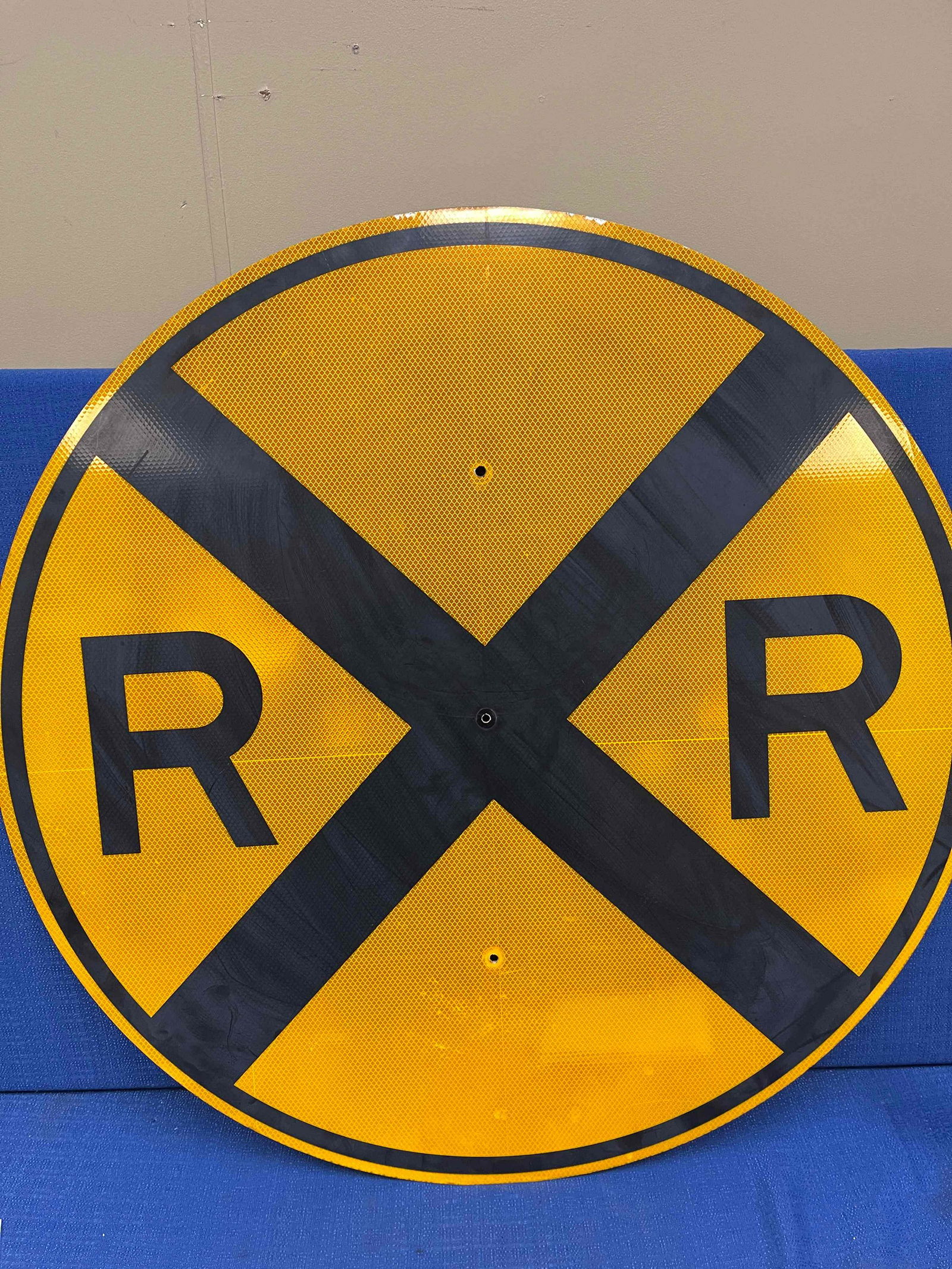 Metal Railroad Crossing Sign: Metal Railroad Crossing Sign with yellow and black. Minor blemishes.