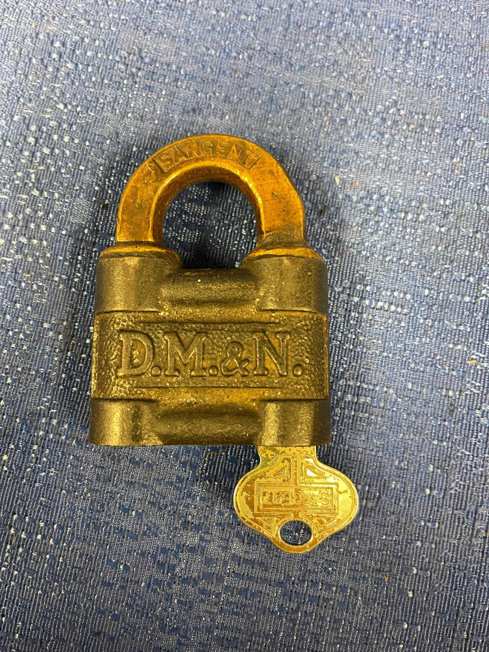 Duluth, Missabe, & Northern Lock: Sargent Lock with key. Brass shackle. D.M.&N. cast on both sides of the lock. Very rare piece!