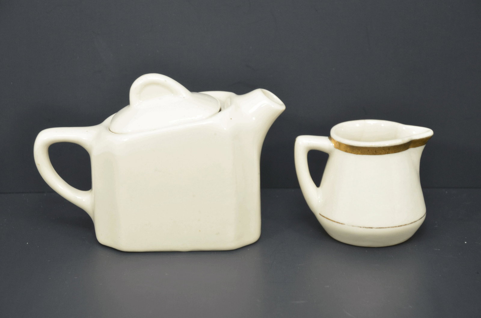 Chesapeake and Ohio RR Teapot and Creamer: This is a Chesapeake and Ohio Railroad teapot and creamer. The teapot is 4 inches in height, and is made by Buffalo China in the Ye Olde Ivory pattern. The creamer is similar and 2.75 inches in height