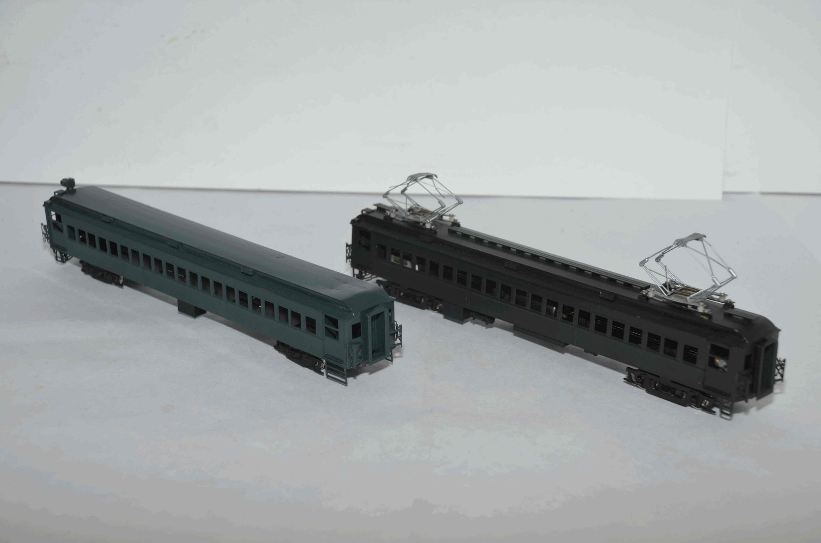 Two Brass Passenger Coaches-One Motored Coach: This is a pair of brass passenger coaches of unknown origin, but one is powered similar to a Budd Car. We tested it and it runs, but needs servicing to run better. The powered car also has two pantogr