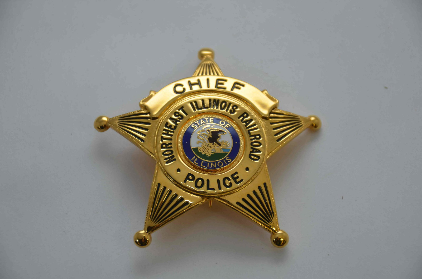 Northeast Illinois Railroad Police Chief Badge: This is a Northeast Illinois Railroad (now known as METRA) police chief badge. Made by Blackinton. Excellent condition and complete with pin!