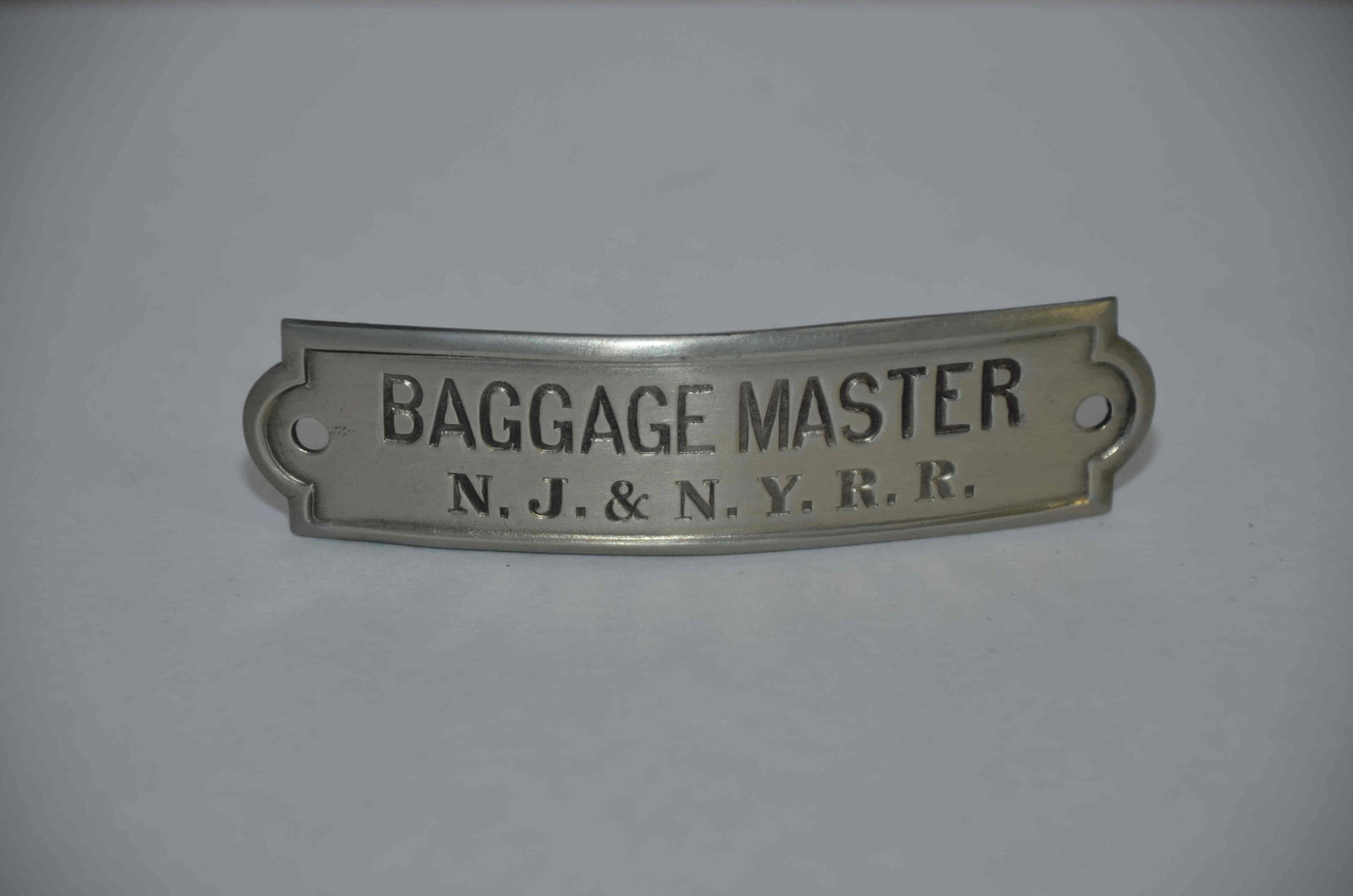 New Jersey and New York RR Baggagemaster Hat Badge: This is a rare, hard to find baggagemaster hat badge from the New Jersey and New York Railroad. Nice original condition. This railroad began in the 1870s and was later leased to the Erie Railroad in 1