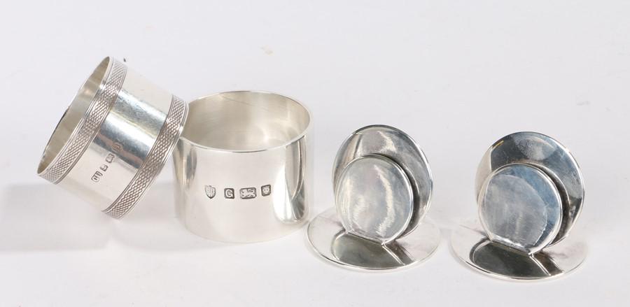 Pair of George V silver place markers, Chester 1912,: Pair of George V silver place markers, Chester 1912, maker Sampson Mordan & Co Ltd, formed from two circular discs mounted on a circular base, George VI silver napkin ring, London 1942, maker Edward B