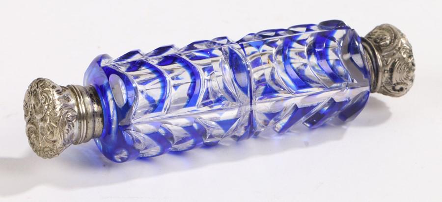 Edwardian glass double ended scent bottle, the blue and: Edwardian glass double ended scent bottle, the blue and clear glass body with white metal screw and hinged caps, 10cm long