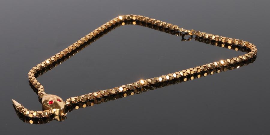 18 carat gold and ruby set necklace, in the form of a (1 of 2)