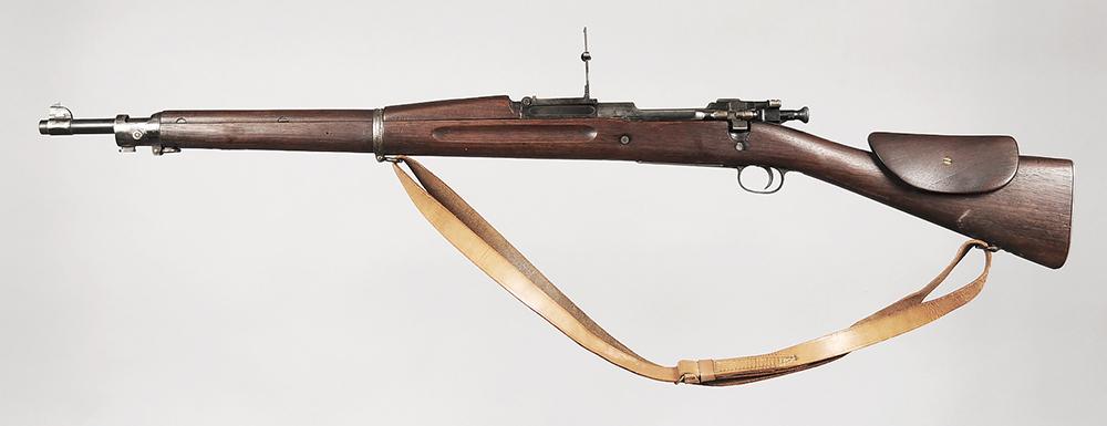 US Springfield Model 1903 Bolt Action Rifle: .30-06, S/N 388555 (1909), 24 in barrel, metal flip up rear sight graduated to 2700 yards, blade post front sight, accepts a knife bayonnet, metal buttplate with hinged door, added screwed in raised c
