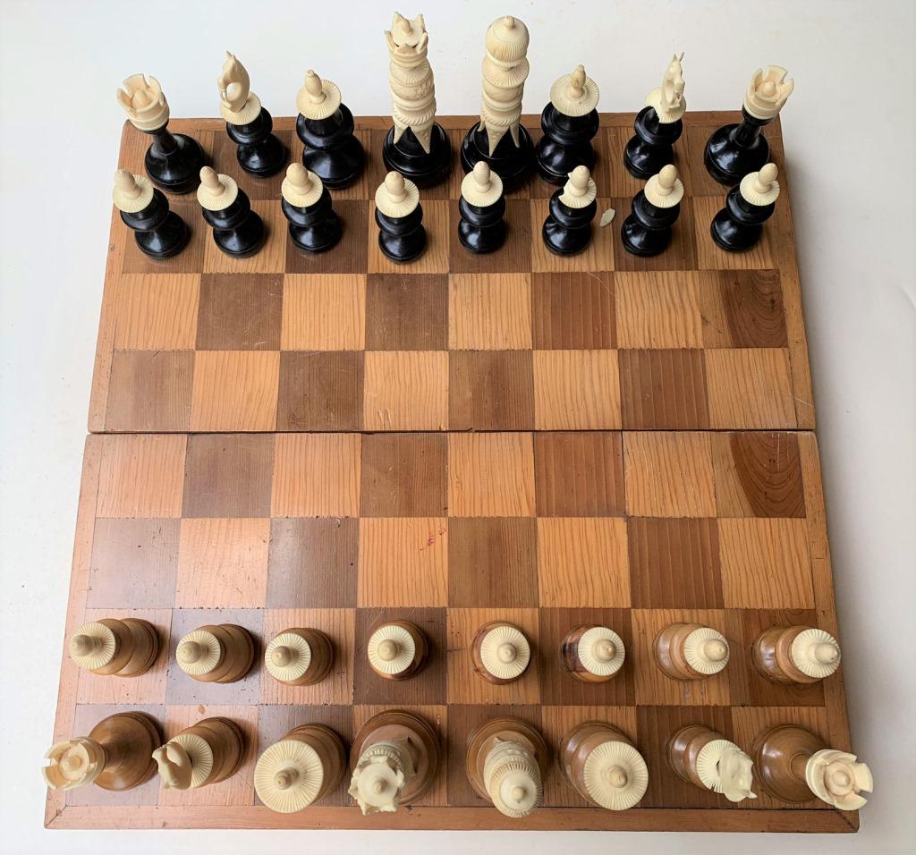 Vintage Wood and Bone Chess: Vintage Wood and Bone Chess In Game Board Storage Box. 32 pieces. Unsigned. Three with lose or cracks. Some wear and scratched to box. King measures 5-1/2" H. Box measures 17-3/4" square when open for