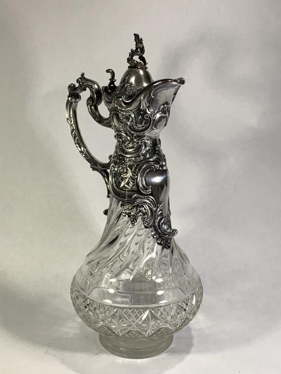 Antique Continental Glass and Silver Ewer: Large Antique Continental Glass and Silver Ewer. With repousse 800 silver mounted on swirled glass body with hinged top. Polished pontil bottom Signed 800, hallmarks. There is a vertical internal crac