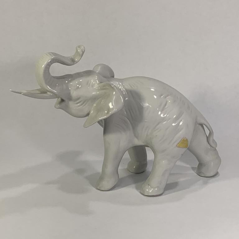 Royal Dux Elephant: Royal Dux Porcelain Elephant With Raised Trunk. Signed. Small chip to one tusk or in good condition. Measures 6-1/4" H x 9-1/2" L.