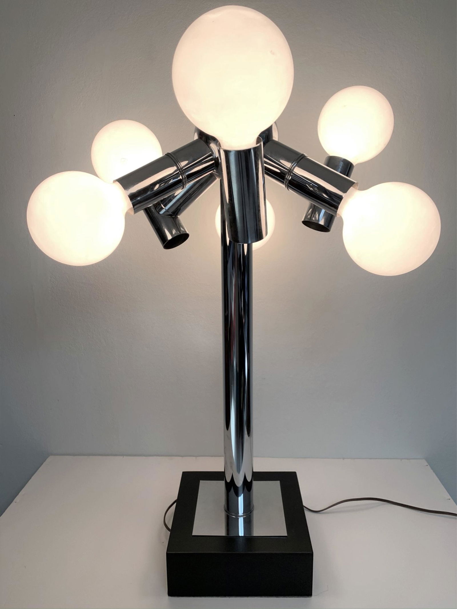 Robert Haussmann Table Top Atomic Lamp. Three way: Robert Haussmann Table Top Atomic Lamp. Three way lighting. Bulbs included but optional. Unsigned. Very Good condition. Measures 31" H x 22" W, 9" square base.