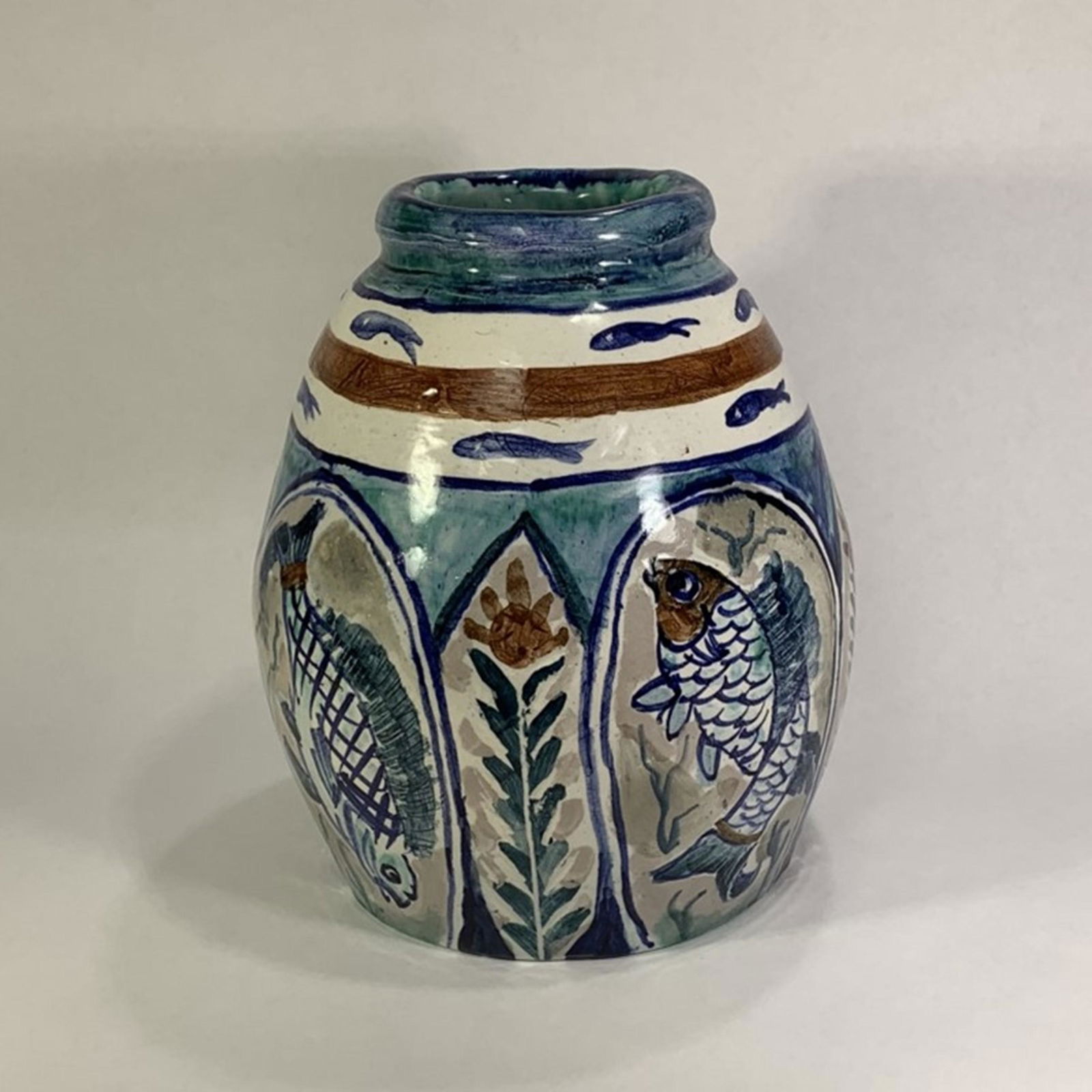 Original Art Pottery Vase by Artist Louise Brokenshaw,: Original Art Pottery Vase by Artist Louise Brokenshaw, American (1907-1992). Beautiful blue vase with detailed fish motif and abstract floral design. Good Condition. Signed on Bottom. Measures 8" H x