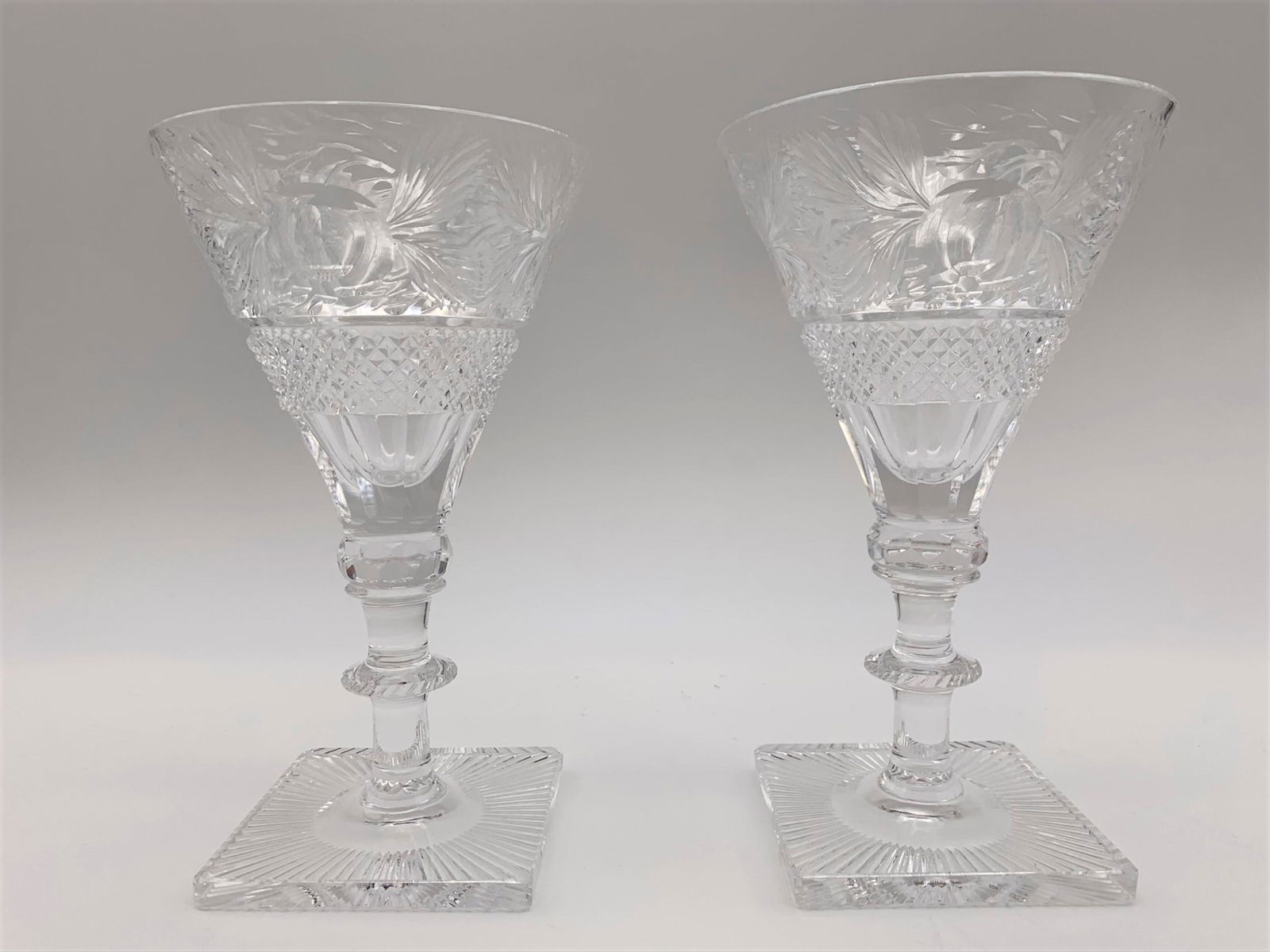 Pair Antique Steven & Williams Crystal Wine Glasses.: Pair Antique Steven & Williams Crystal Wine Glasses. Decorated in an intaglio multi fruit motif, bulbous stem and striated square feet. Unsigned. Good condition, no chips or cracks. Measures 6-5/8" H.
