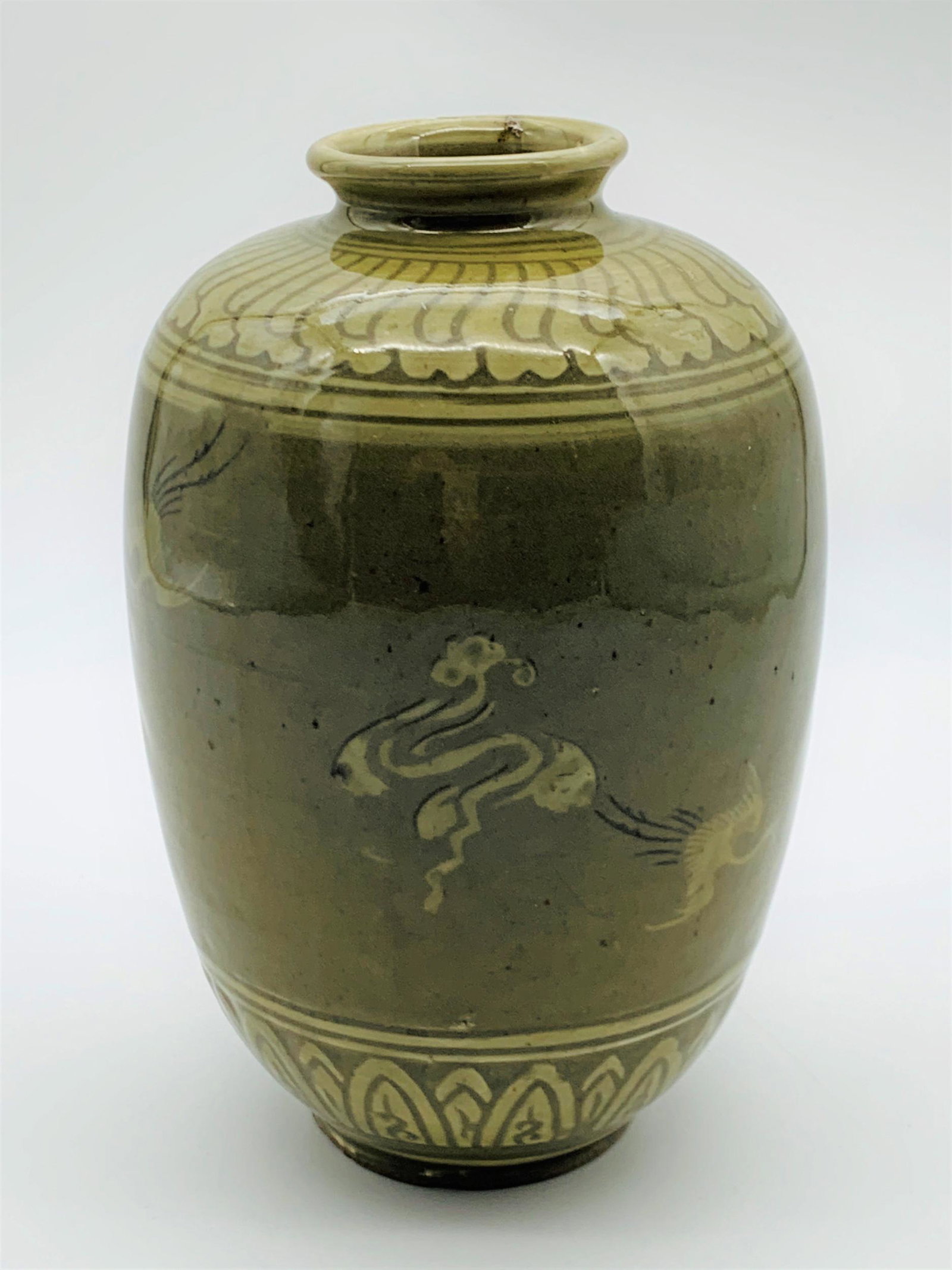 Vintage Korean Porcelain Crane Vase: Vintage Korean Porcelain Crane Vase. Olive green in color with flying cranes motif. Stamped on bottom. Good condition with small ding on rim. Measures 8" H x 5" W.