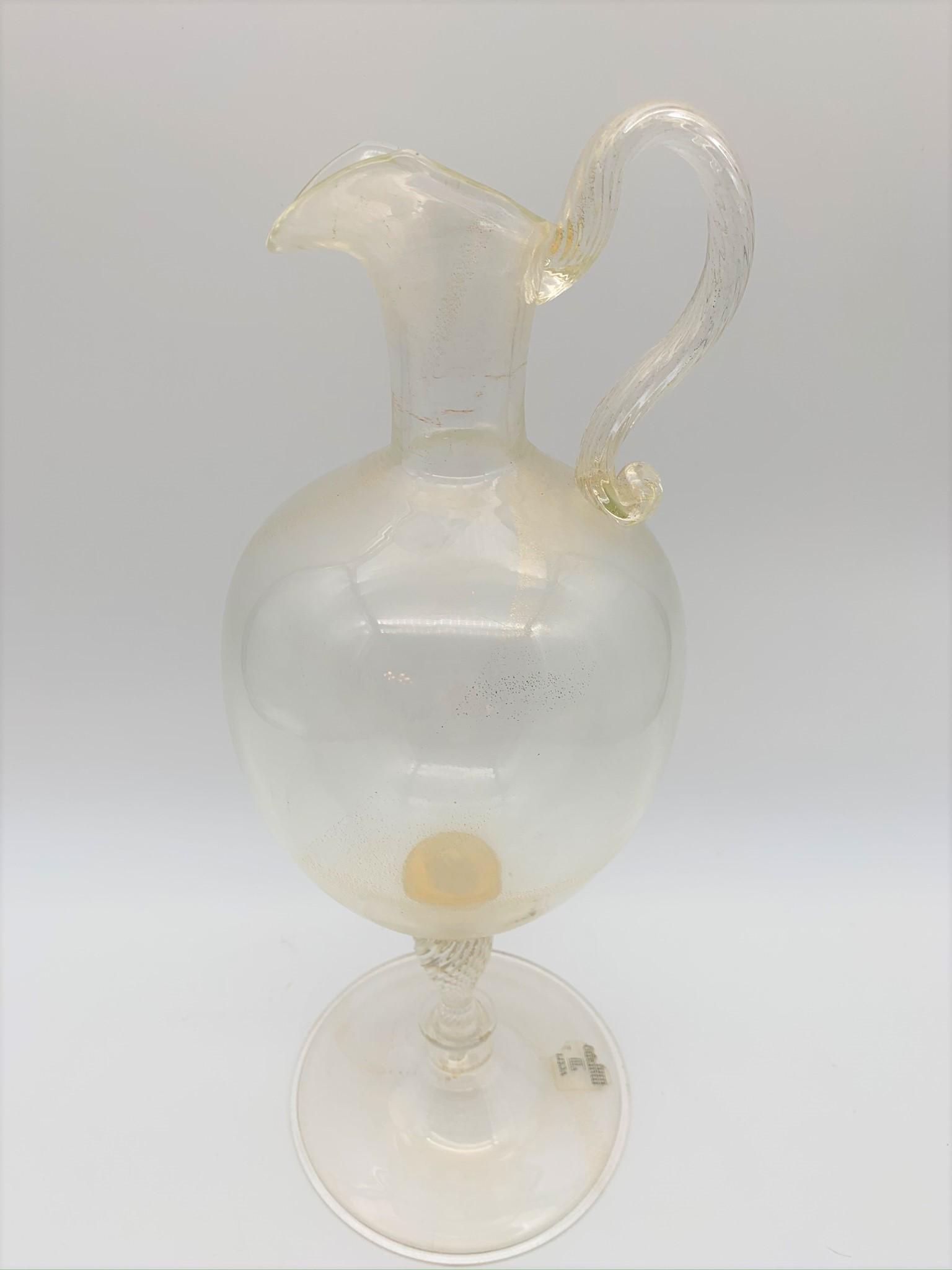 Vetri Murano Glass Zecchin Style Ewer: Vetri Murano Glass Vittorio Zecchin Style Ewer. With clear glass and gold flaked bulbous body, applied swirled ribbed handle and stem. Clear Vetri Murano label. Good condition, no chips or cracks. Mea