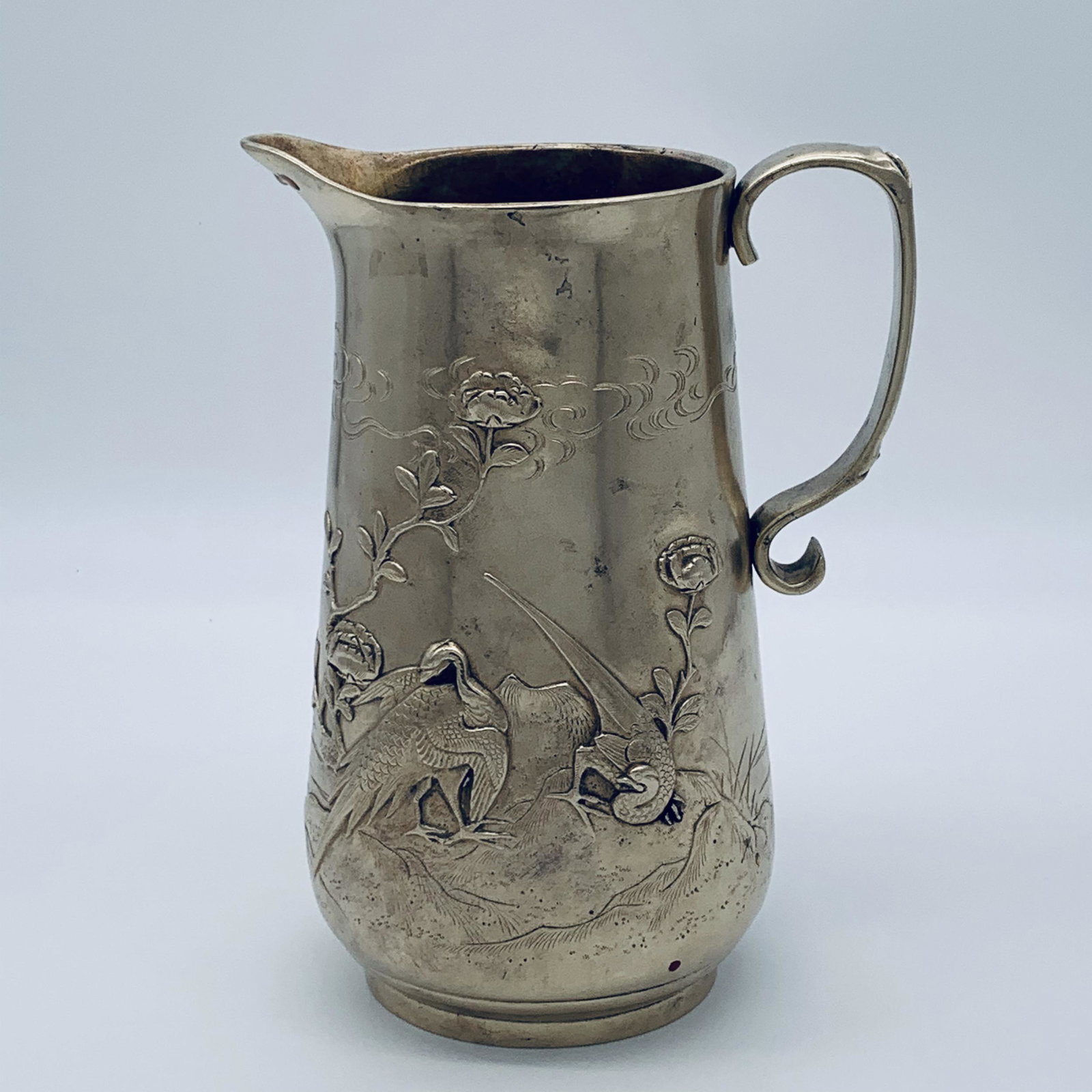Japanese Meiji Period Bronze Pitcher: Japanese Meiji Period Bronze Pitcher, Decorated in relief of birds, flowers and insects. "Silvered Style Finish". Signed. Good condition. Measures 8-1/2" H x 6-1/2" W. Free Local Pick-up Available Wit