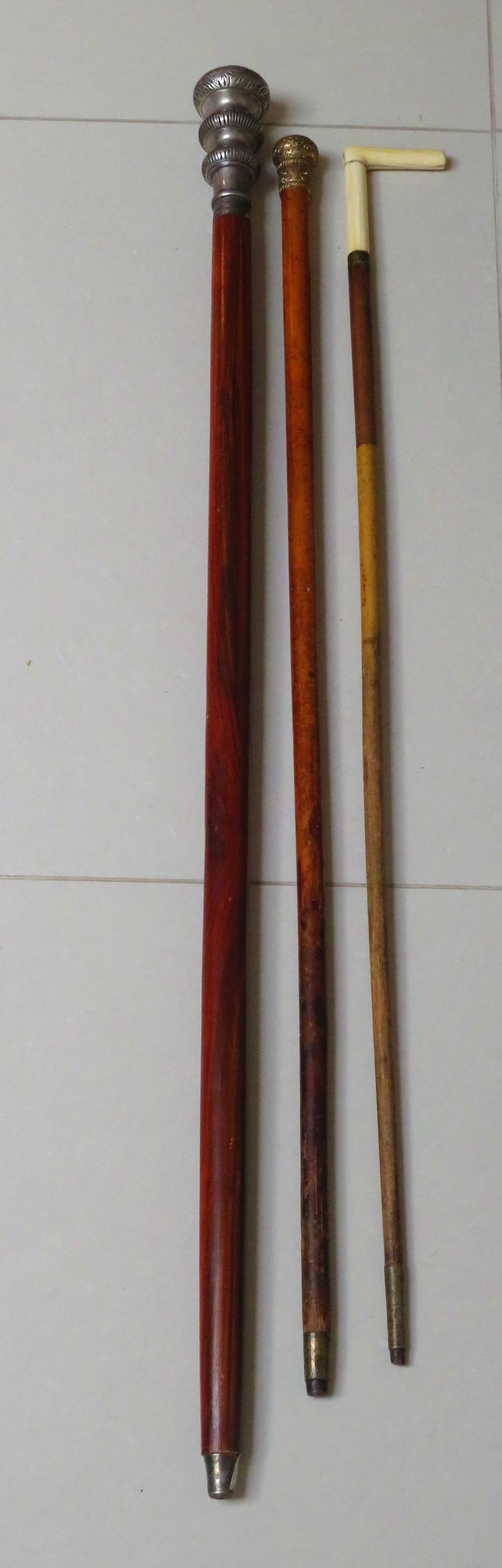 3 Antique Canes / Walking Sticks: 3 Antique Canes / Walking Sticks. Included one with silver plate handle 38-1/2 L, chased gilt metal handle 34-1/2" L, Bone and bamboo 34" L x 3" W. Unsigned. Wear, rubbing consistent with age.