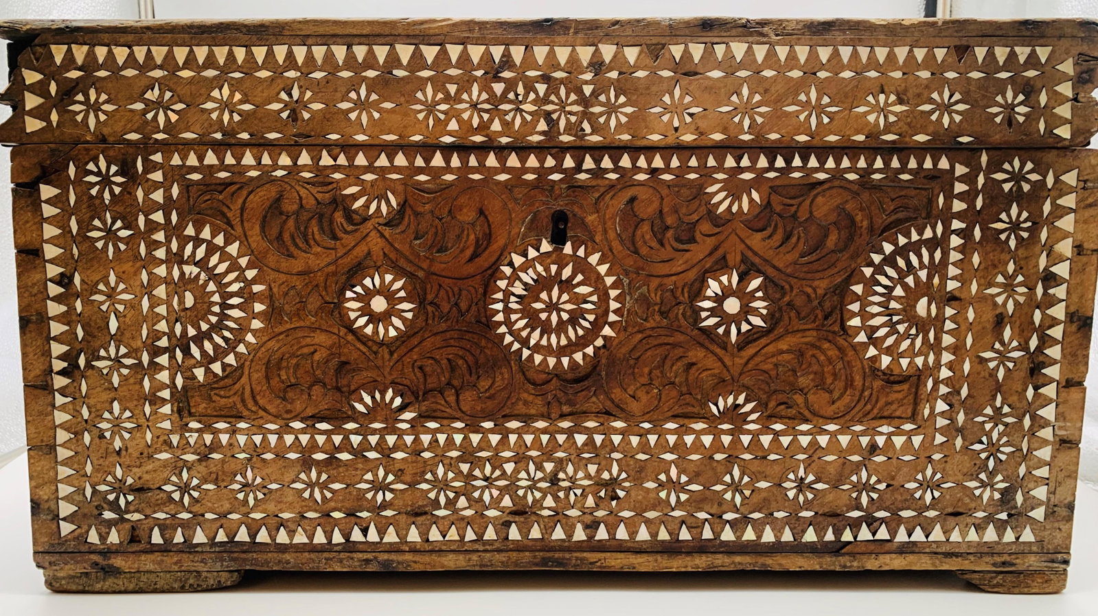 Vintage Syrian Carved Wood Inlaid Chest: Vintage Syrian Carved Wood Inlaid Chest. Unsigned. Age cracks, losses and wear consistent with age. Measures 12" H x 21-1/2" L x 11-1/4" D.