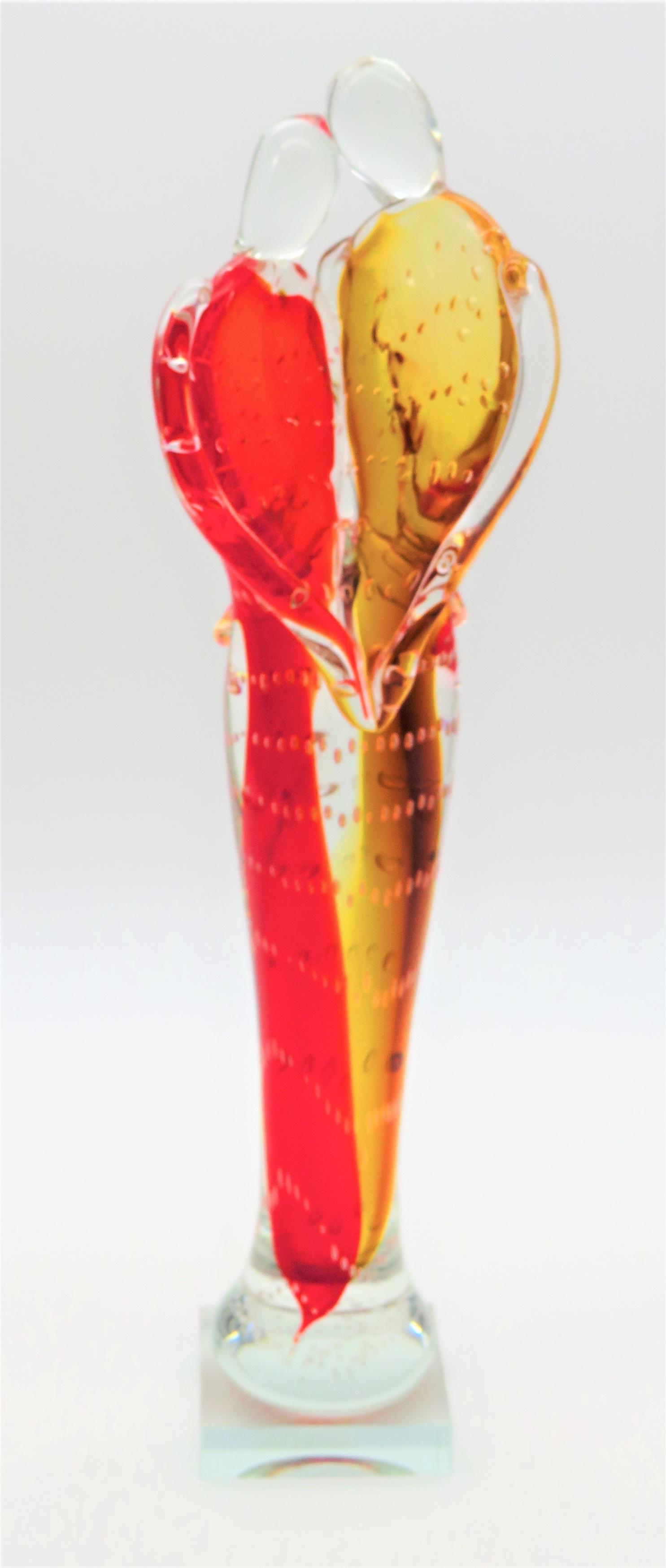 Dale Tiffany Art Glass Embracing Couple: Dale Tiffany Art Glass Embracing Couple. Signed. Clear Label. Measures 17" H x 4-1/2" W. Third party shipping.