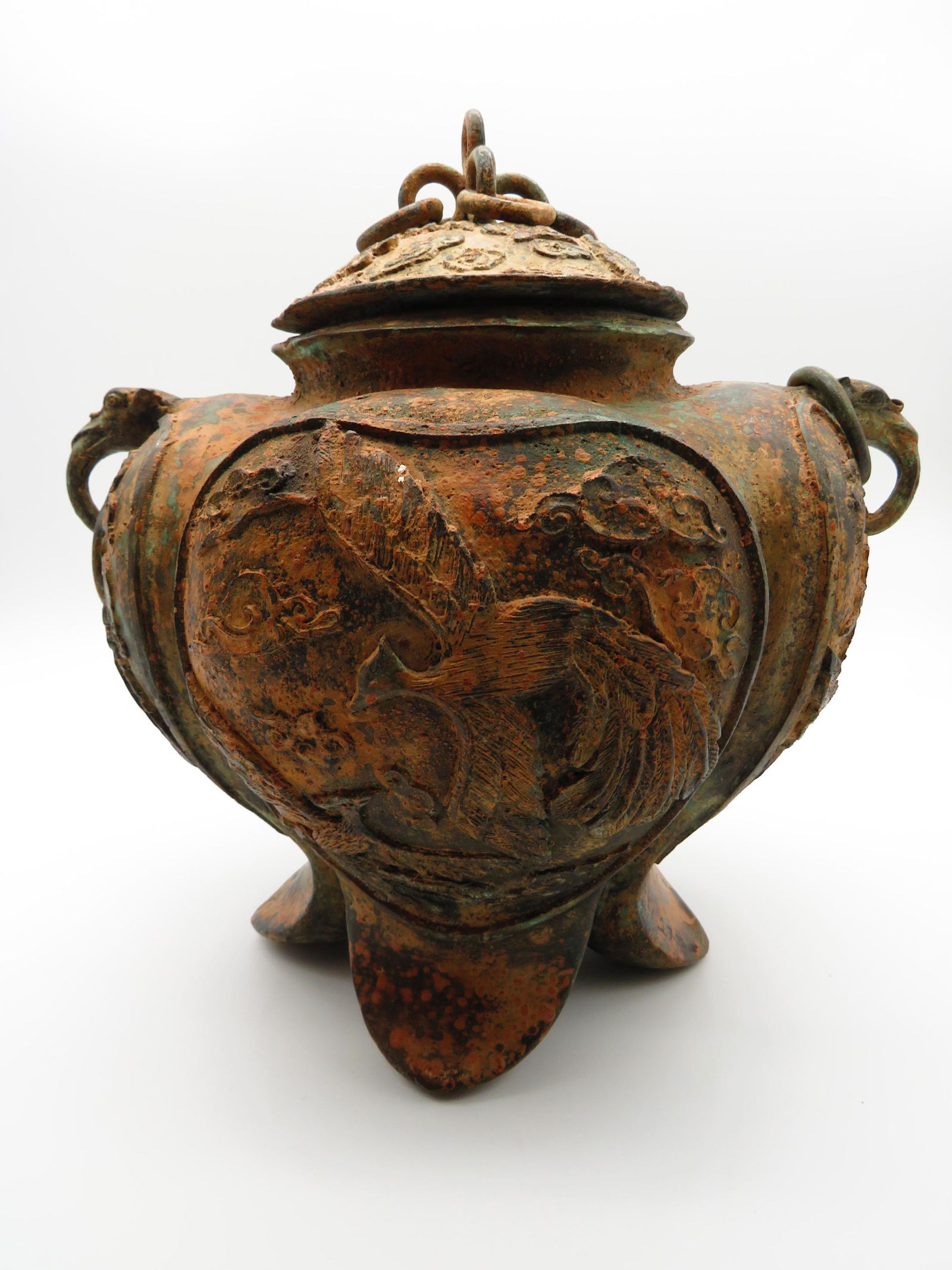 Chinese Ancient Style Bronze Vessel: Chinese Ancient Style Bronze Vessel. Elephant head ring handles. Unsigned. The lid will not come off or in good condition. Measures 12-1/2" H x 13" W. Third party shipping.