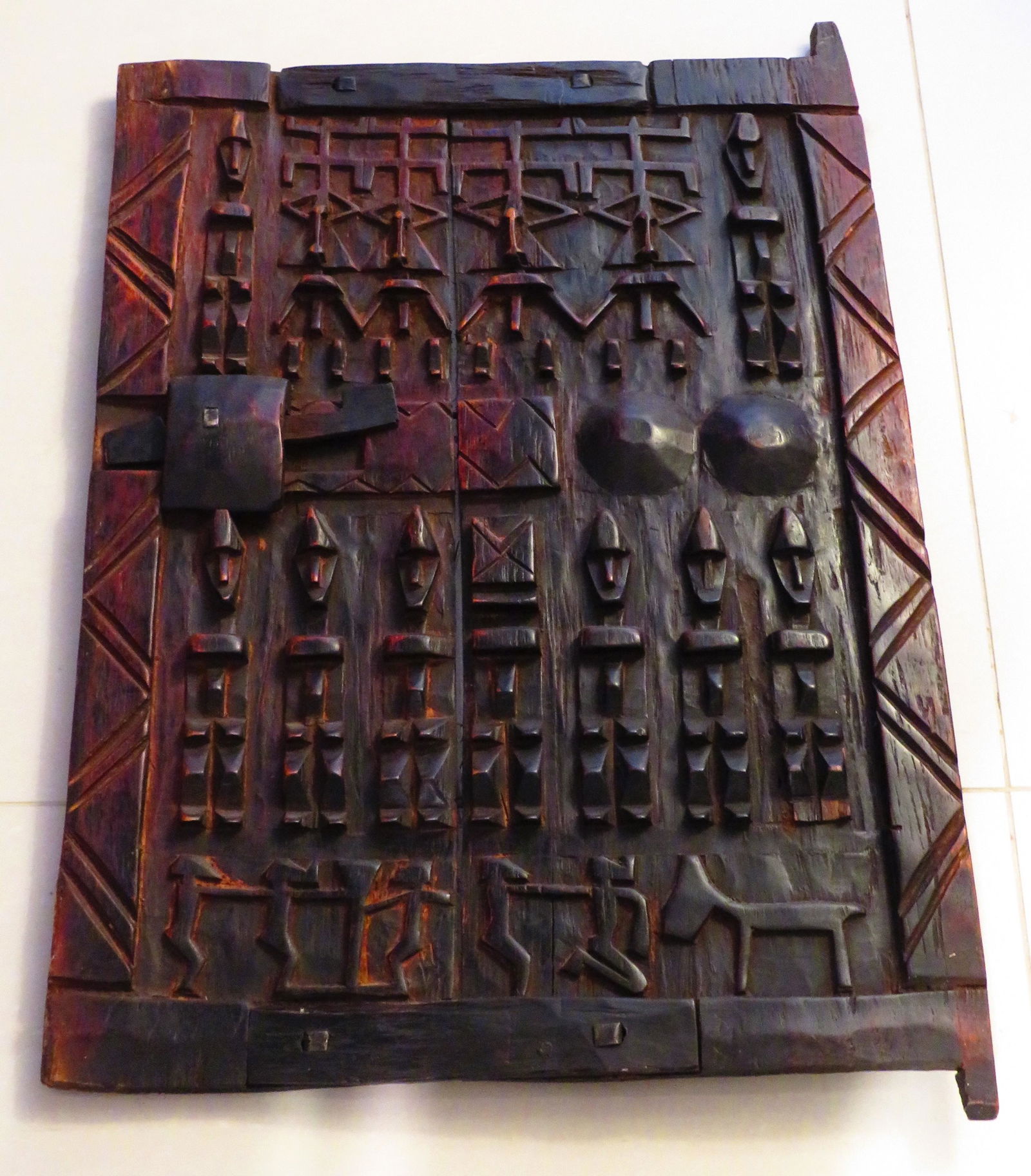 Dogon African Carved Wood Granary Door: Dogon African Carved Wood Granary Door. Unmarked. Condition consistent with age and use. Measures 26-3/4" x 18-1/2". Weighs approx. 5lbs. Third party Shipping.