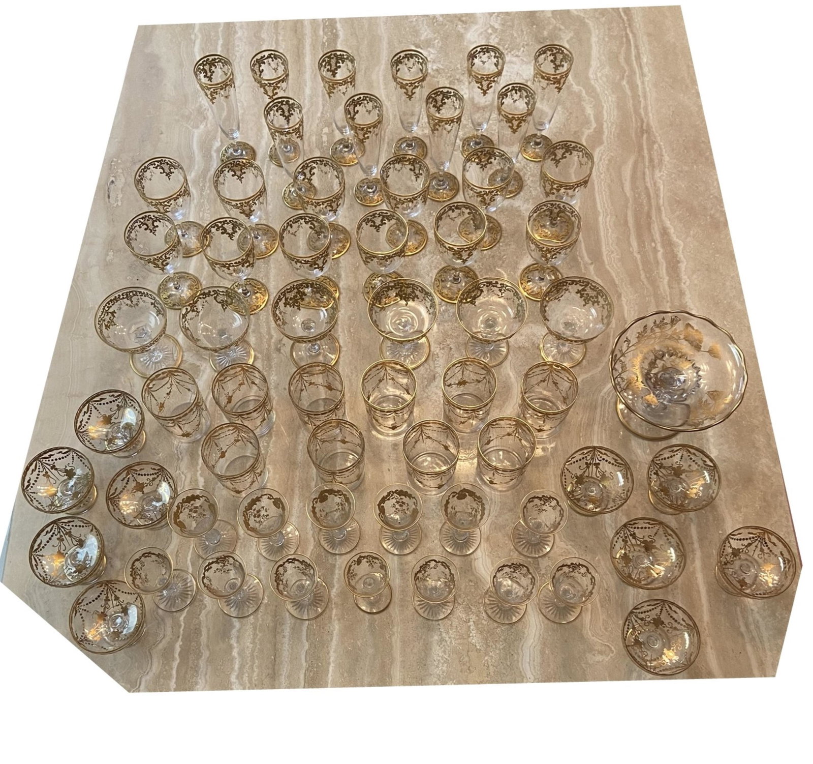 62 Pc Elegant Edwardian Gilt Crystal Stemware: 62 Pc Elegant Edwardian Gilt Crystal Stemware This assembled set is in the style of Baccarat, St Louis, Moser etc. Very fine thin crystal with hand painted gilt designs. Unsigned. The set includes the