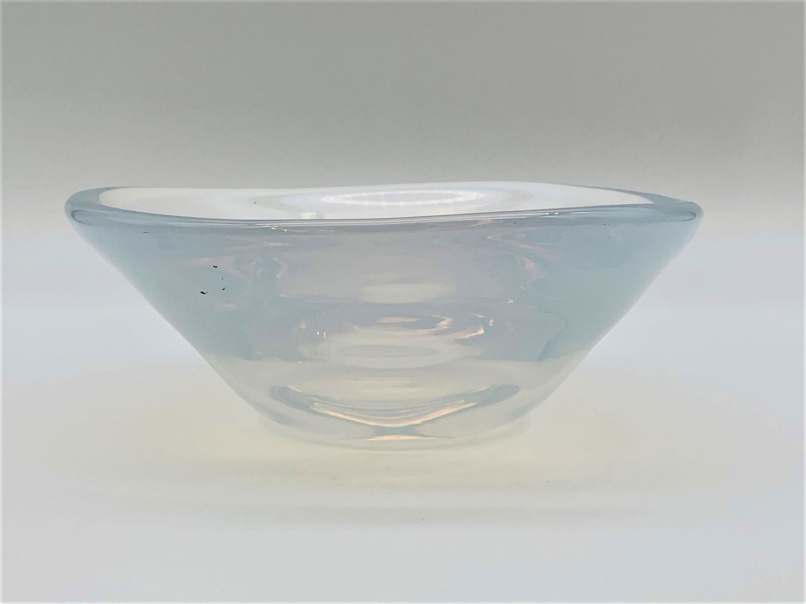 Vintage Orrefors Selena Blue Opal Glass Bowl: Vintage Orrefors Blue Opalescent Glass Bowl. Signed. A few light scratches on body, scratches on bottom from age and use. Measures 3-1/2" H x 8-3/4" W. Third party shipping.