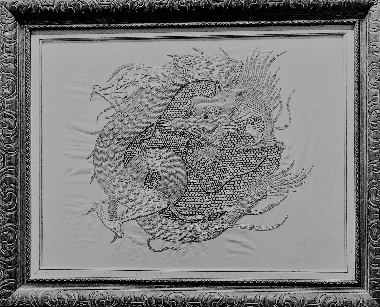 Antique Chinese Silver Embroidery Dragon: Antique Chinese Silver Embroidery Dragon. Silver embroidery on silver fabric ground. Well done and intricate. Framed under glass. Light stains from age and moisture, small wear spots or in good overal