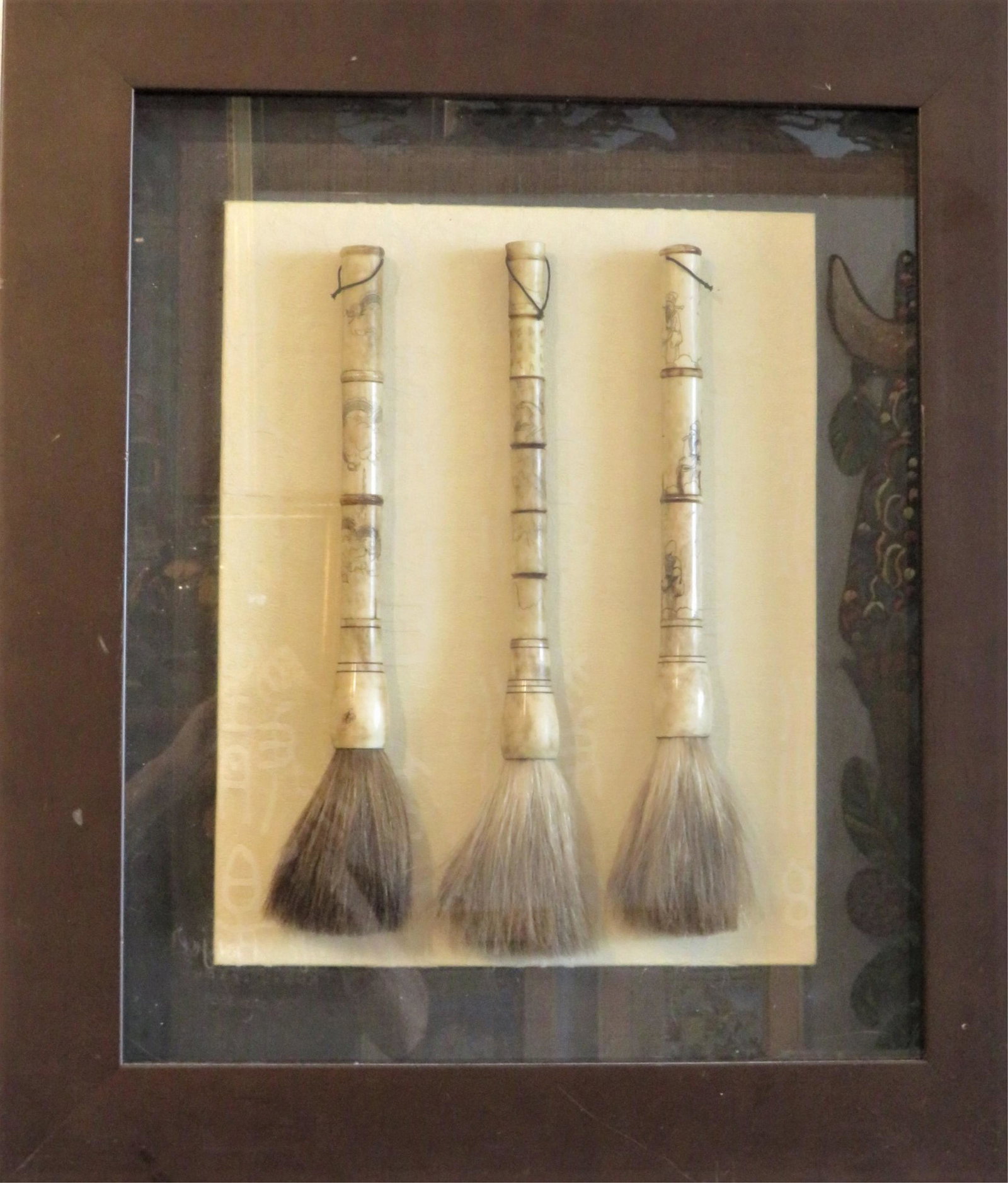 3 Antique Chinese Artist Brushes In Shadowbox: 3 Antique Chinese Artist Brushes In Shadowbox Frame. Bone handles with scrimshaw style designs and natural animal hair bristles. Unsigned. Very good condition. Brushes measure approx. 18" L. Overall f