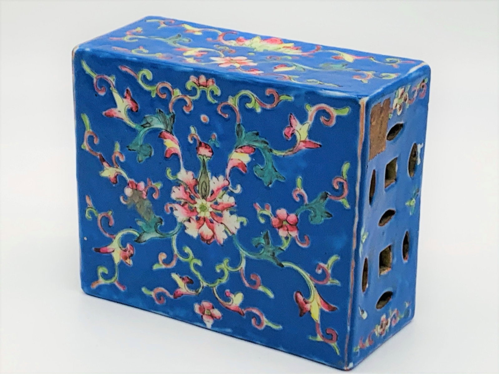 Vintage Chinese Enameled Porcelain Pillow: Vintage Chinese Enameled Porcelain Pillow. Pretty floral and bat motif on blue ground. Reticulated sides. Old label, Stamped CHINA. Good condition. Measures 4-7/8" x 6" x 2-1/2". Third party shipping.