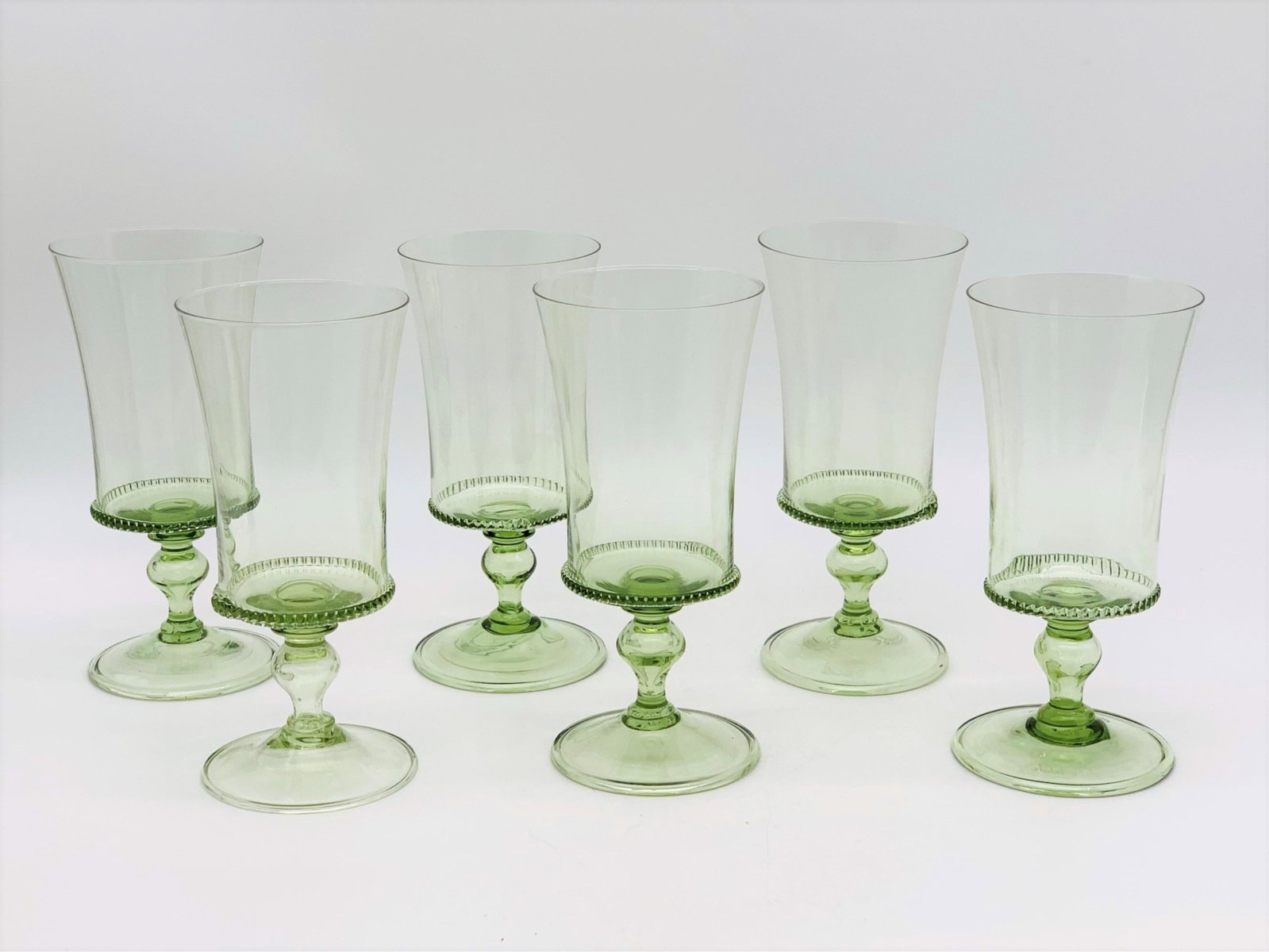 Six Juliska Fiorella Water Goblets: Set of Six Juliska Fiorella Green Glass Water Goblets. Signed. Good condition. Measures 7-1/8" x 3-3/8". Third party shipping.