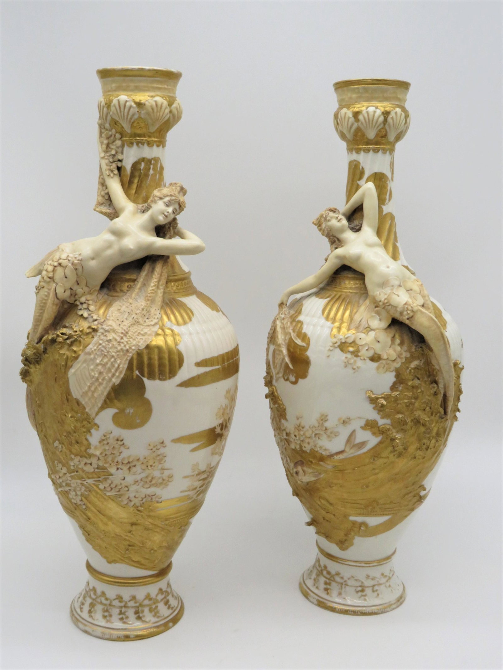 Pair Amphora/Austrian Figural Porcelain Vases: Pair of Large Amphora/Austrian Art Nouveau Partial Gilt Porcelain Vases with Raised Nude Figures. Unsigned. Rubbing to the gilded surface. Measures 18" x 7-1/2". Third party shipping or free local pic