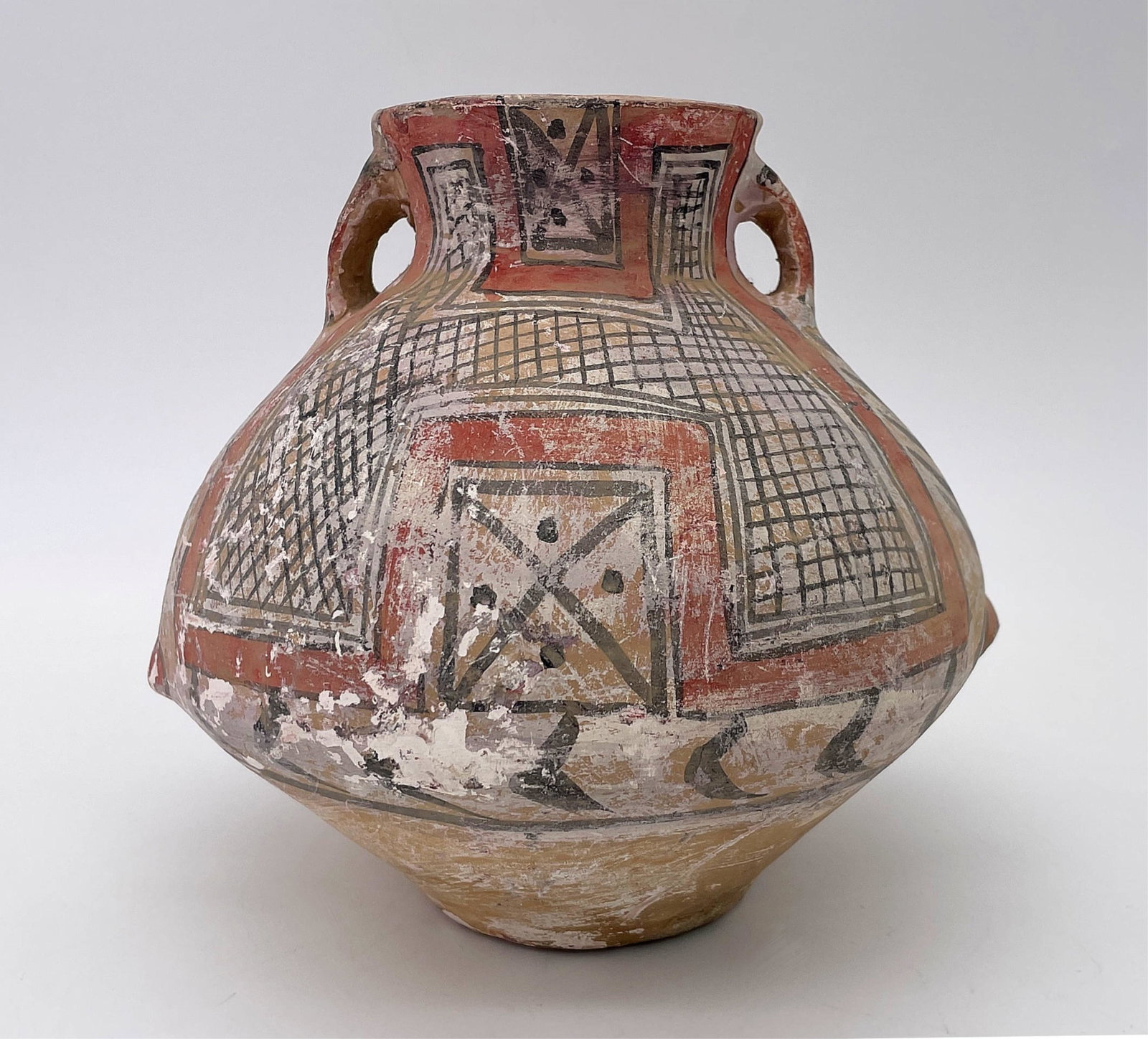 Pre-Colombian Polychrome Earthenware Handled Pot: Pre-Colombian Polychrome Earthenware Handled Pot. Incised mark on bottom. Wear and rubbing consistent with age. Measures 6-3/4" H x 7-1/2" W. All Items Are Third party shipping or free local pick-up w