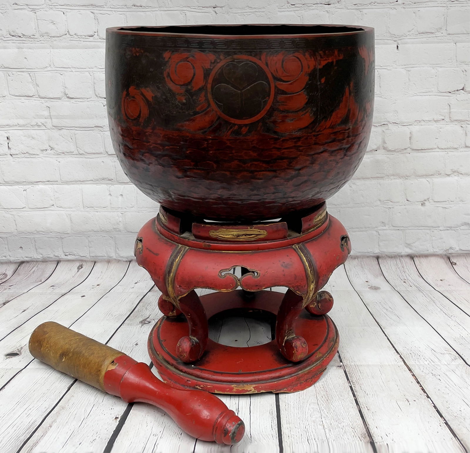 Antique Japanese Rin Gong Singing Bowl On Stand: Antique Japanese Rin Gong Singing Bowl On Stand. Hand hammered and decorated with dragon and sun motif complete with red lacquered stand and leather covered ringer. Unsigned. Some surface wear from ag