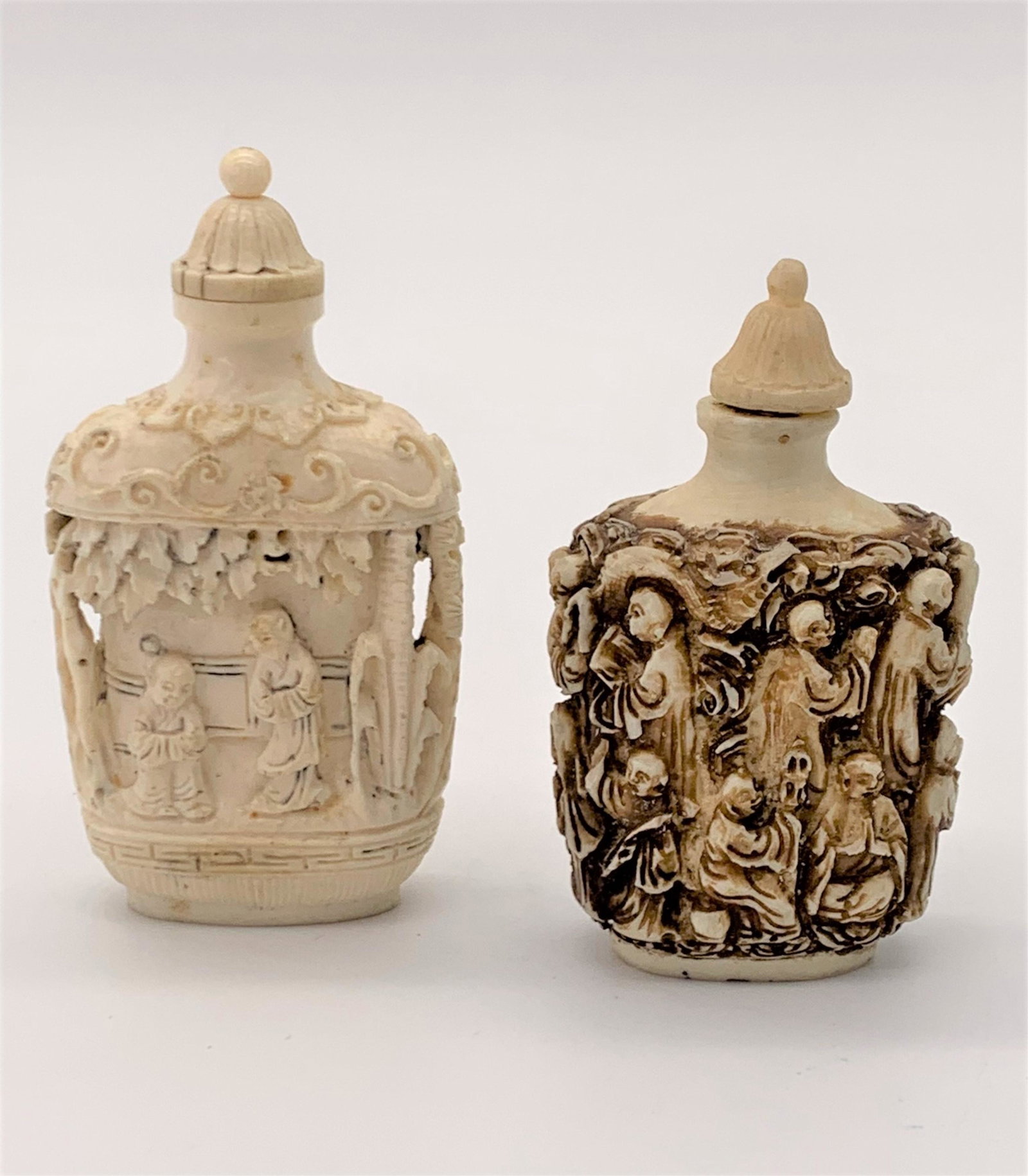 2 Antique Chinese Carved Figural Snuff Bottles: 2 Antique Chinese Carved Figural Snuff Bottles. Both carved in relief, he slightly smaller with dark brown stain. Unsigned. Good condition. Measures 3-1/2" H & 3-1/4" H. No International Shipping. Thi