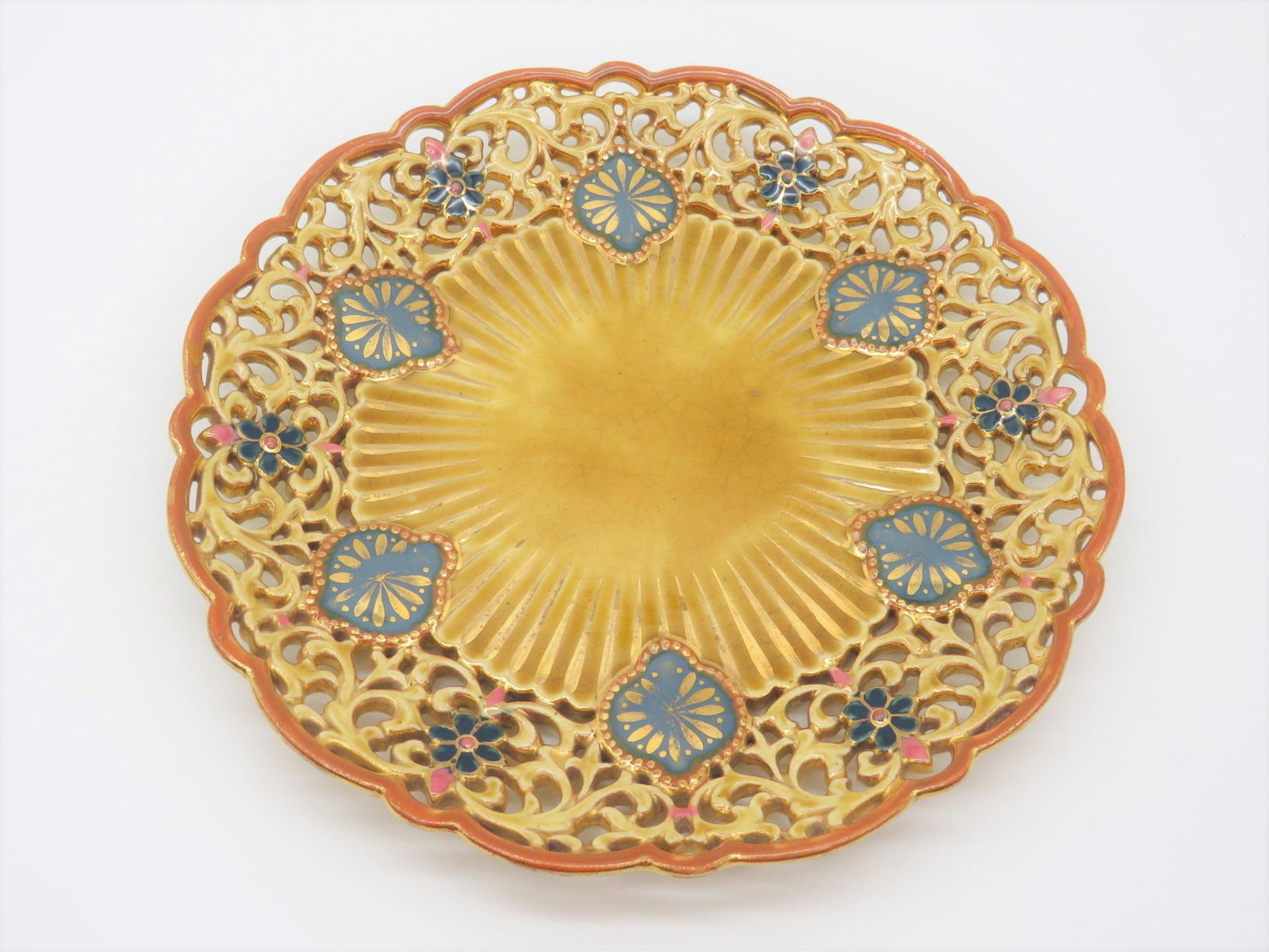 19 C Zsolnay Reticulated Plate: 19th Century Zsolnay Reticulated Plate. Hand painted and gilt motif. Impressed "Zsolnay Pecs 2241" and marked with the early Zsolnay ink stamp logo. Wear and crazing consistent with age. No chips or c