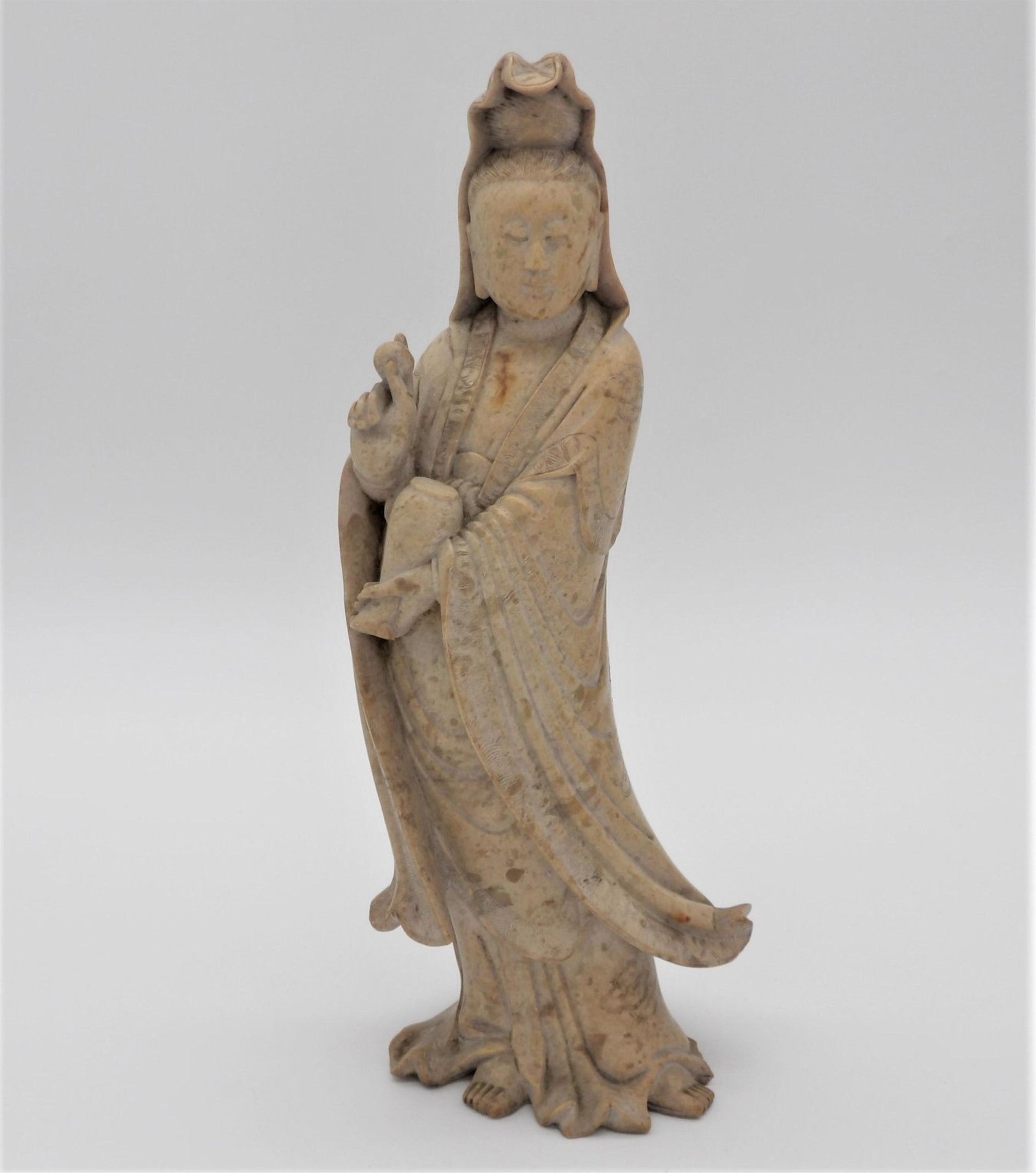 Antique Chinese Carved Soapstone Guanyin Figure: Antique Chinese Nicely Carved Soapstone Guanyin Figure. Old MADE IN CHINA Import label on bottom. Minor nicks to hem of robe, repair to hand or in good condition. Measures 10-1/2" H x 4-1/2" W. Third 
