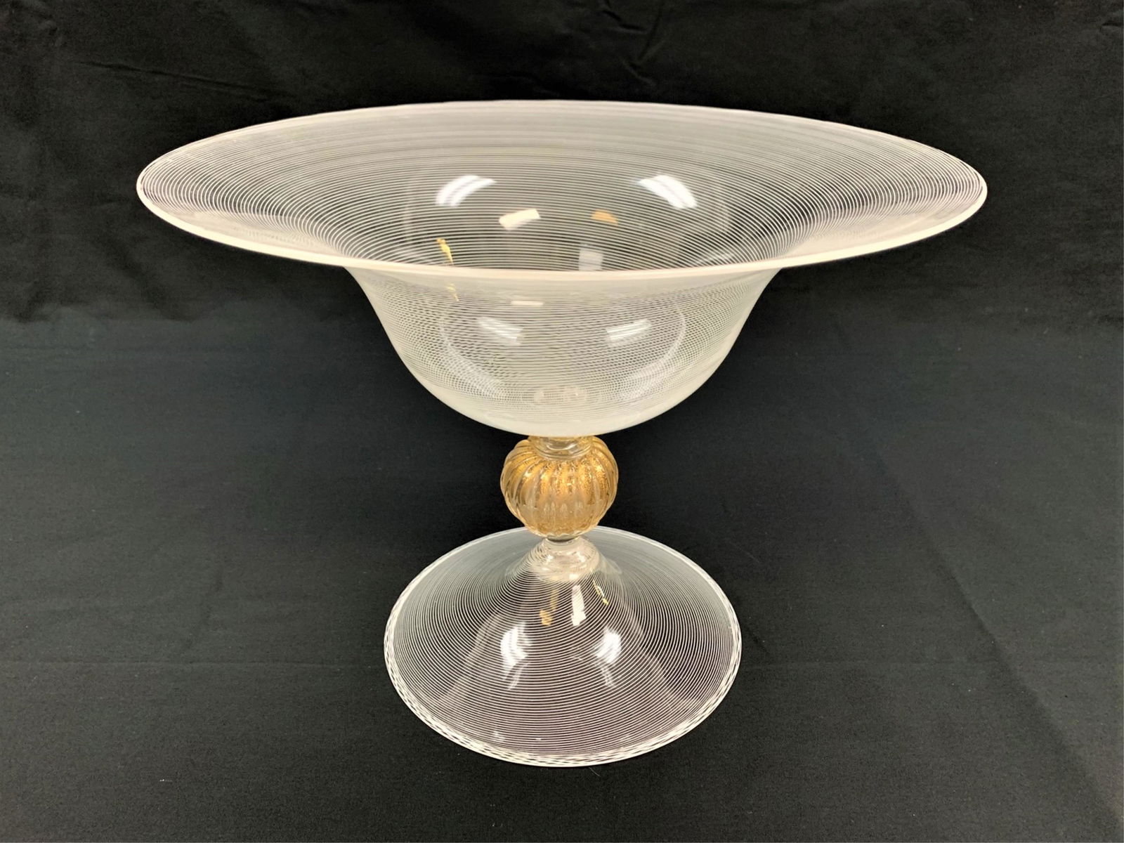 Fine Vintage Murano Seguso Footed Bowl: Possibly Flavio Poli, Fine Vintage Murano Seguso Soffiato Footed Bowl. This large bowl features fine linear filigree with center gold flecked knob stem and flared foot base. 9" H x 11-3/4" W. Third pa